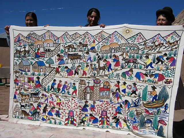 Artisans from Chijnaya with a tapestry depicting village life